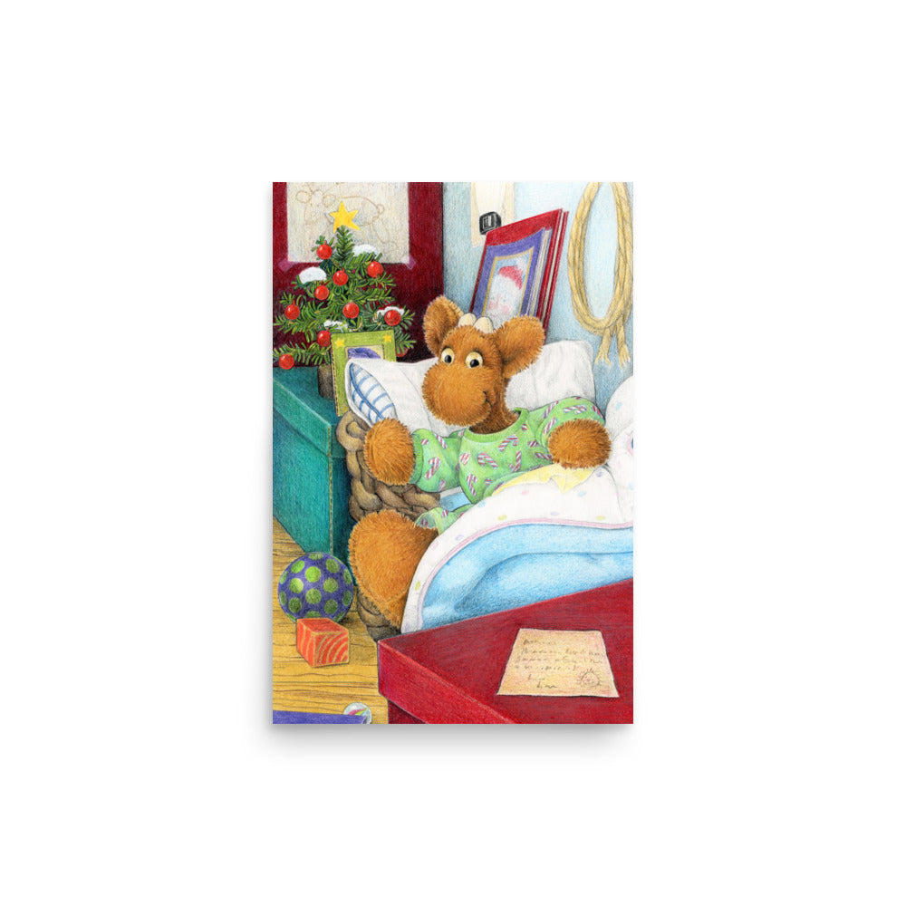 Elliot Moose a children's book character, is jumping out of his basket bed to look at a big red box at the end of his bed. A Christmas tree is in the back ground. From the Book Elliot's Christmas Surprise by Andrea Beck